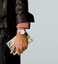 Baume & Mercier model wearing male watch. Tap to shop mens watches image
