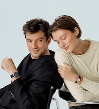Baume & Mercier male and female models wearing watches. Tap to shop all watches image