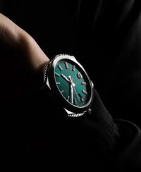 Image of ID Geneve watch with green dial on wrist. Tap to shop ID Geneve watches image