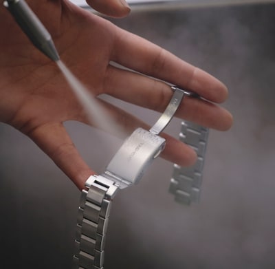 Watch bracelet being washed image