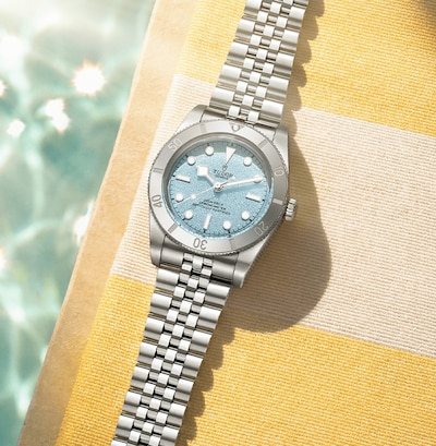 Image of Tudor black bay watch on striped beach towel image