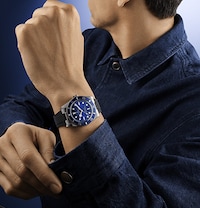 Image of model wearing Tudor watch. Tap to shop all new watches image