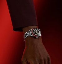 Image of male model wearing Tudor black bay watch. Tap to shop all mens tudor watches image