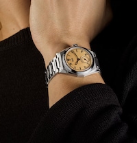 Image of model wearing Tudor watch. Tap to shop all new tudor watches image