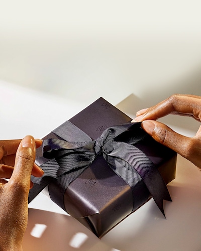 Business and Corporate Gifting Image - Hands Untying a Ribbon on Gift Box image